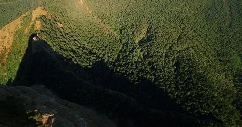 Aerial cenital drone shot while going backwards towards mountain Stock Footage 75175285