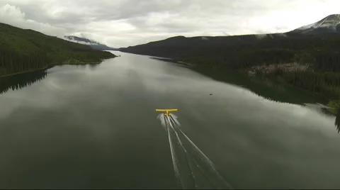 AERIAL CHASE SHOT OF FLOAT PLANE TAKE OFF IN LAKE BC CANADA Stock Footage 62758187