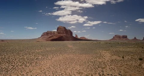 Aerial - chasing a dust devil as it winds its way through Monument Valley Stock Footage 107114537