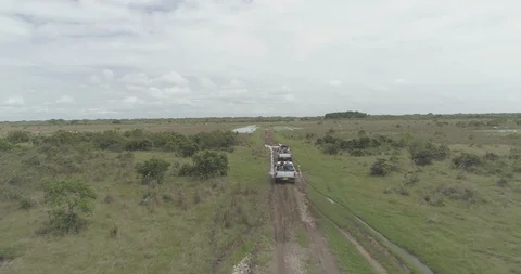 Aerial chasing trucks driving through the Llanos Orientales of Colombia Video stock 92825083