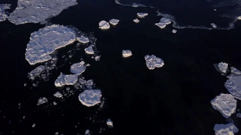 Aerial of chunks of Sea ice floating in a black ocean  Stock Footage 304028697