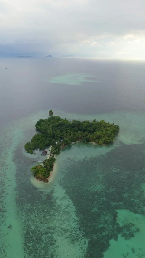 Aerial Cinematic Flight Over Remote Fishing Village Island Raja Ampat 動画素材 336983858