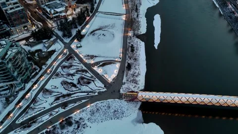 Aerial Cinematic Top-Down Calgary Peace Bridge, Delta Garden, and Eau Claire Stock Footage 333548747