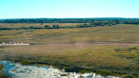 Aerial cinematic view from drone which is pursuit a buggy car going in cross  Stock Footage 162514778