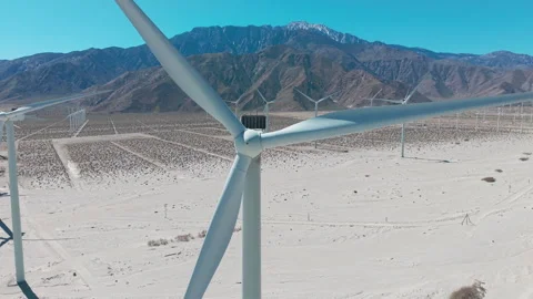 Aerial cinematic view of single windmill turbine in Palm Springs desert Video stock 334641420