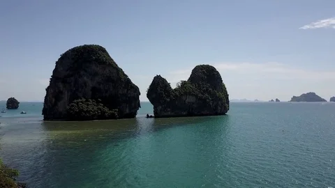 Aerial cinematic view: Tall cliffs, tropical emerald sea, many boats, beach Stock Footage 73053247