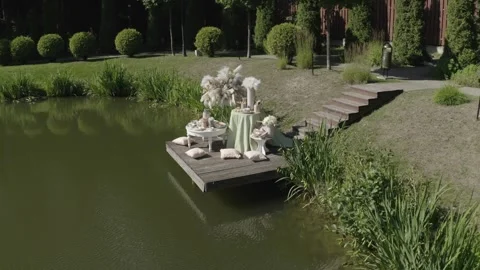 Aerial circle around pond side installation Stock Footage 329833045