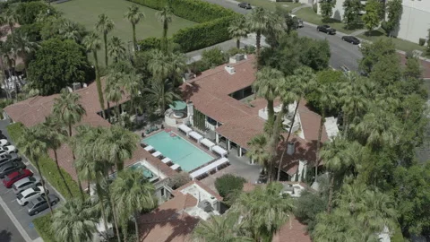 Aerial circles high around a pool of Villa Royale in Palm Springs, California Vídeos de archivo 156043891