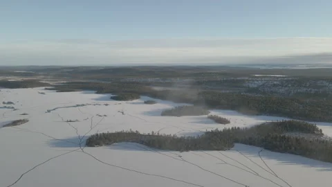 Aerial Circling Drone Shot Of Cloud Above Frozen Lake Inari On Sunny Day Stock Footage 224248656