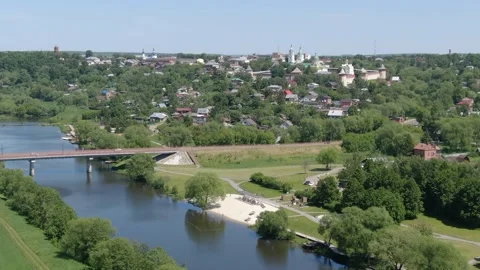 Aerial circular side flight over river and town Stock Footage 331829244