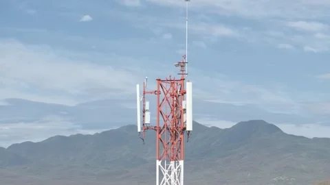 Aerial circular view of a telecommunications tower in rural mountain landscape Видео 260422277