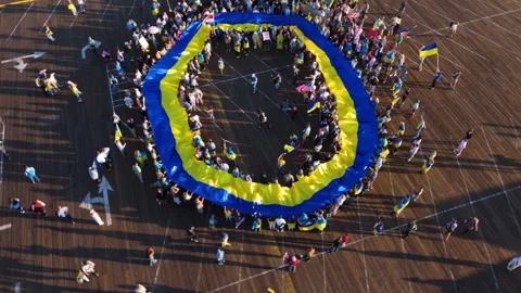 Aerial Circular View of Ukrainian Flag Rally on Santa Monica Pier, Los Angeles Stock Footage 303388277