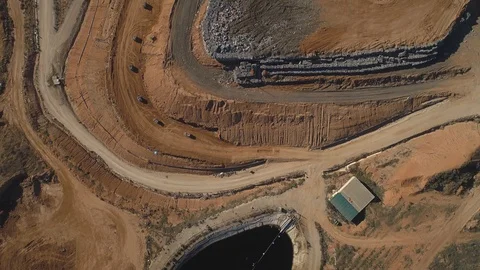 Aerial: City dump. Compressed in cubes garbage stacked and covered in soil Video stock 102033236