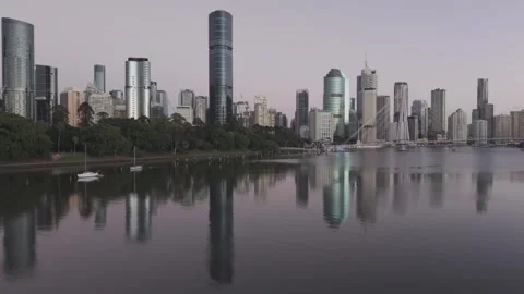 Aerial of the City Skyline Reflected in the River at Dawn Video stock 345084792