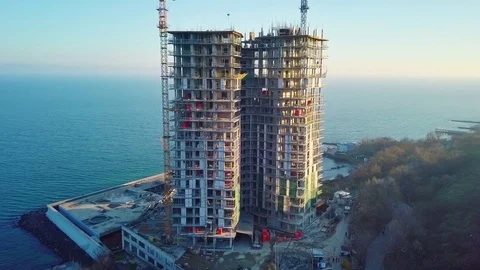 Aerial city view. Construction of a high-rise skyscraper on the ocean by two Stock Footage 83320357