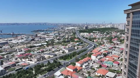 Aerial Cityscape: Ocean, Buildings, Roads, and Clear Blue Sky Stock Footage 341973653