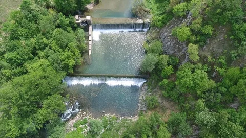 Aerial clear narrow river flows among green forestry hills Stock Footage 101742340