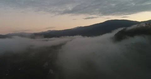Aerial clip at dawn above clouds in a rural valley of Costa Rica Stock Footage 86573992