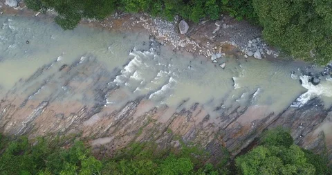 Aerial clip of flying down to a river lowland tropical rainforest of Costa Rica Stock Footage 86571111