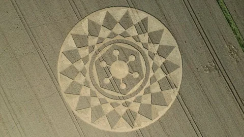 Aerial clip of an intricate geometric crop circle Wiltshire, England, UK Stock Footage 258015553