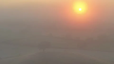 Aerial clip of rolling Devon countryside at dawn on a misty summer morning, Stock Footage 283947912