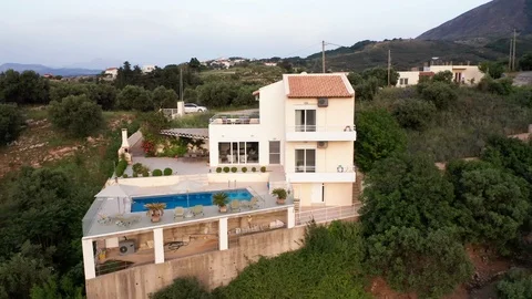 Aerial Clockwise Fly Around of Luxury Greek Villa with Pool with Mountains Video stock 109616883