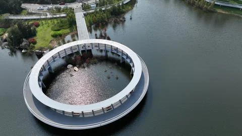 Aerial Close-Up of Circular Ring Walkway with Sunlit Water, Xiamen China Stock Photos