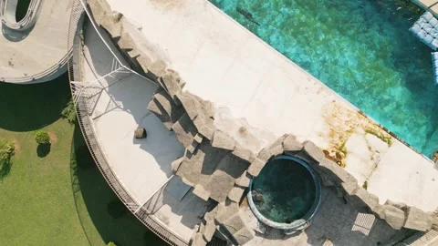 Aerial close up of dolphins kept in small concrete pools at dolphinarium sh.. Stock-Footage 318154854