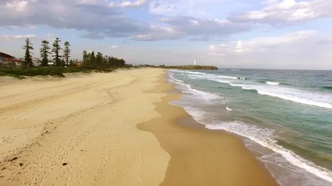 Aerial close flight over sand on a quiet beach Video stock 83535022