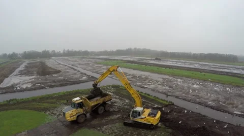 Aerial close by footage of excavator moving sand mud into dump truck 4k Stock Footage 59331959
