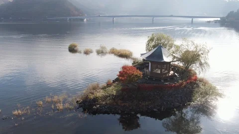 Aerial close orbit shot of Hexagonal japanese temple built in Fuji lakes area 스톡 동영상 98407175