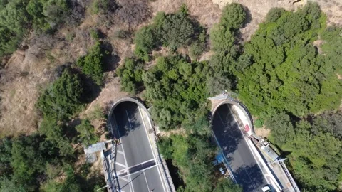 Aerial close-up orbit view of busy highway tunnel entrance bridge Stock Footage 343961068