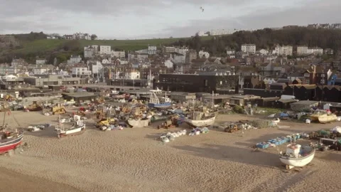 Aerial close up panning view various size fishing boats, nets, houses and on Stock Footage 251045644