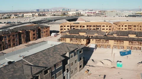 Aerial close up pullback shot of Las Vegas housing construction and city skyline Stock Footage 271155082