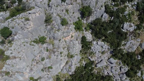 Aerial close-up of rugged cliff texture in Mediterranean canyon terrain Stock Footage 343932673