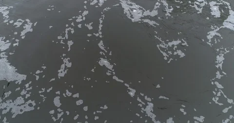 Aerial close up of small stream water pooloing and swirling slow motion Stock Footage 102533378