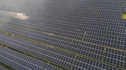 Aerial Close-Up of Solar Panel Farm with Sun Reflection and Photovoltaic Cells Stock Footage 331304671