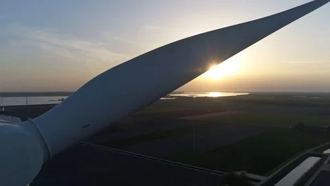 Aerial close up sundown footage of wind turbine 4k Stock Footage 100586990