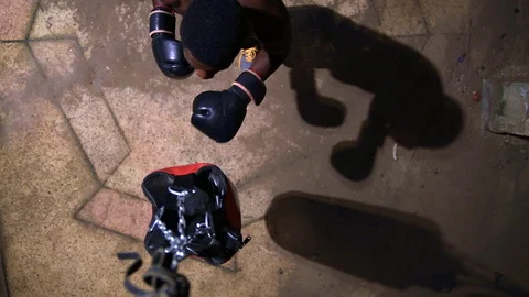 Aerial close up view Boy boxer hitting boxing bag Stock Footage 115915033