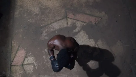 Aerial close up view Boy boxer hitting boxing bag Stock Footage 115915377