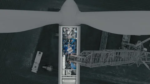 Aerial close up view crane lifting wind turbine Stock Footage 322510147