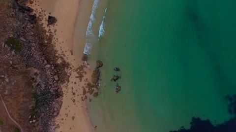 Aerial close view of emerald sea water meeting a sandy beach in Spain Stock Footage 342694899