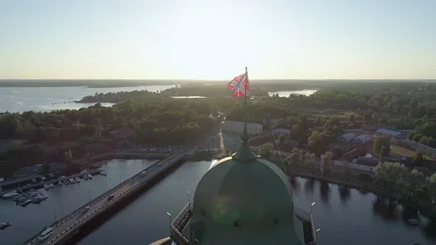 Aerial close-up view of a flag on the top of medieval Swedish castle fortress in Stock Footage 171283998