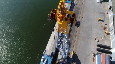 Aerial close up view of harbor crane camera moving down and panning up 4k Stock Footage 110427713