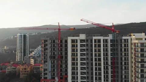 Aerial close up view one crane moving right with building and sky background 動画素材 148335525