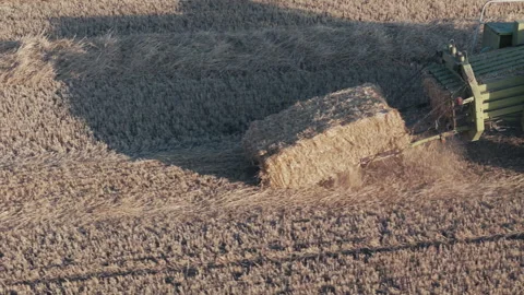 Aerial close up view Square Hay Bales field with tractor Baler Stock Footage 280138335