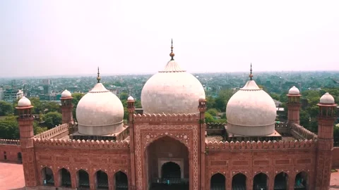 Aerial close-up of the white marble domes of Badshahi Mosque Stock Footage 346321701