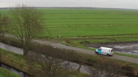 Aerial close up white van moving behind trees driving rural road delivery truck Stock Footage 59919995