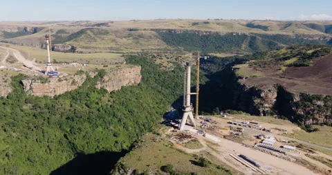 Aerial close-up zoom in construction of Msikaba Bridge in the Eastern Cape, SA Stock Footage 340131348