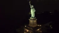 Aerial, Closeup: Famous Statue Od Liberty Lit Up At Night Shining In The Dark Stock Footage